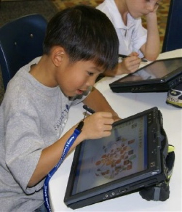 eager boy with tablet, school classroom