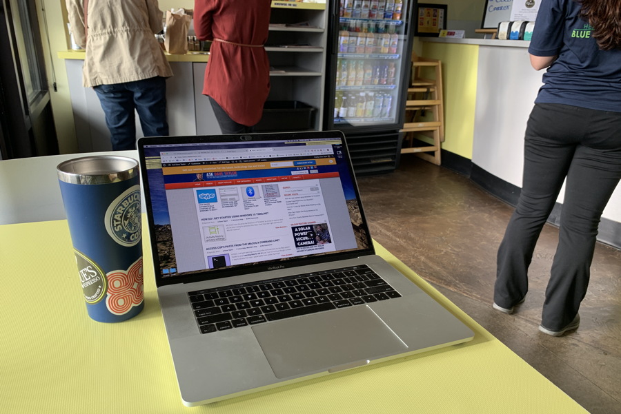 mac laptop at public coffee shop cafe