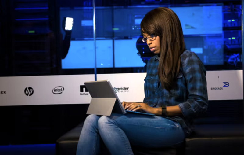 young woman using laptop on stage